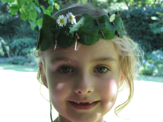 Little girl wearing crown of leaves